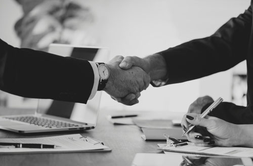 Business partners shaking hands representing SigmaSRCPlus channel partnership program